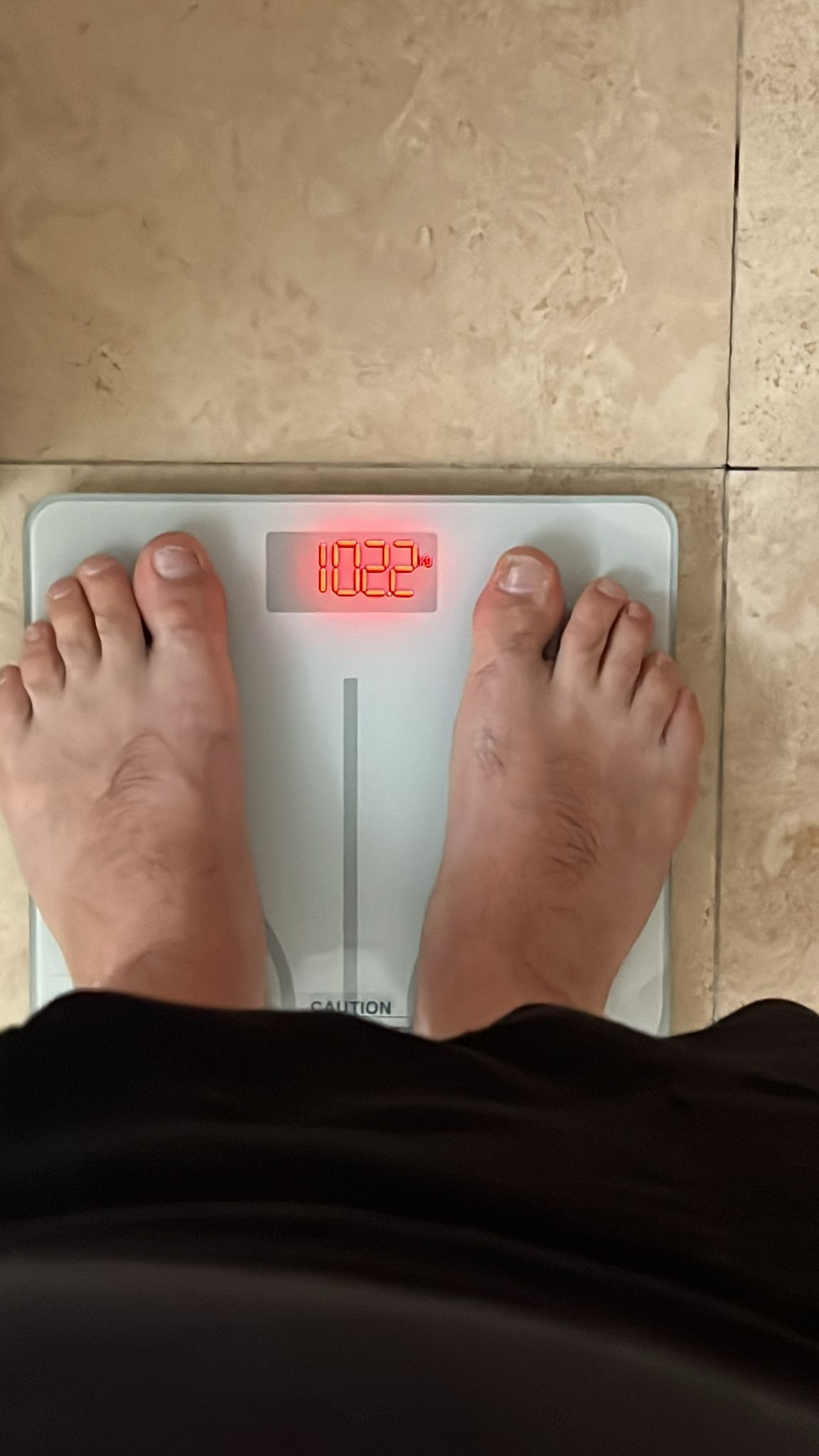 Scale showing 102.2 kg